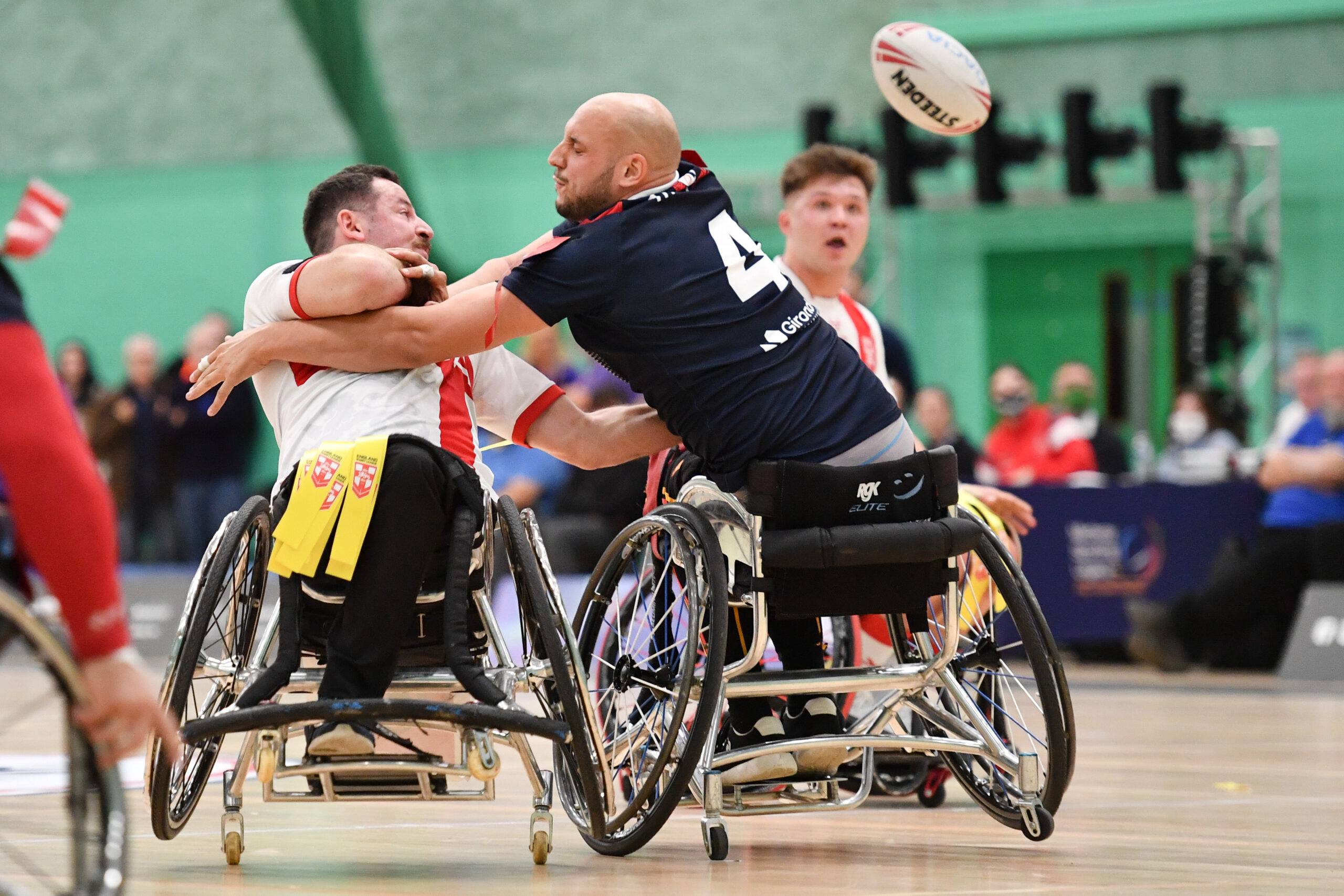 Picture by Will Palmer/SWpix.com – 10/11/2021 – Rugby League – Wheelchair International – England v France – Medway Park Sports Centre, Gillingham, England – Sebastien Bechara of England passes the ball out of the tackle of Jérémy Bourson of France